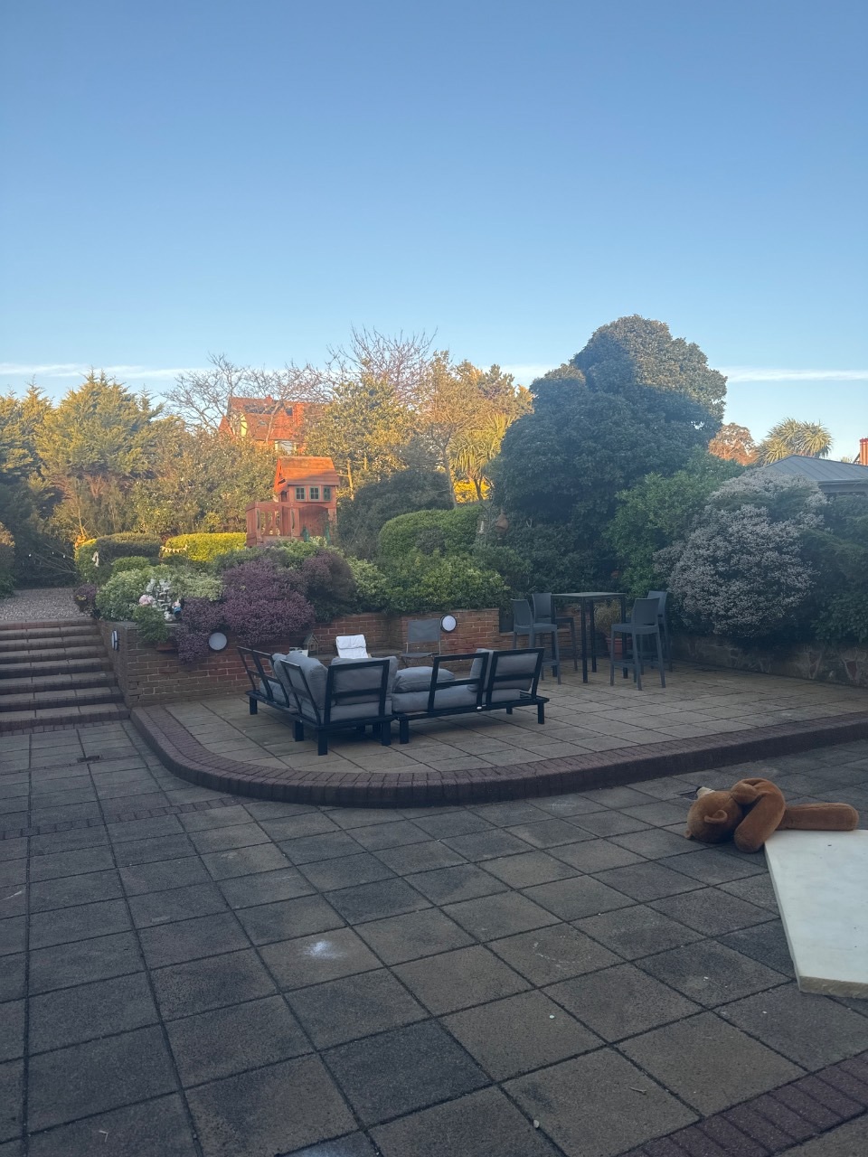 Original photograph of a tired UK garden before redesign, used as the before image inside a TailoredQuote builder quote PDF